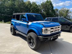 a blue pickup truck parked in a parking lot