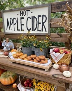 an apple cider stand with apples, donuts and pumpkins