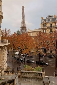 the eiffel tower is seen in the distance from an apartment building on a rainy day