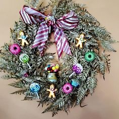 a wreath with christmas decorations hanging on the wall