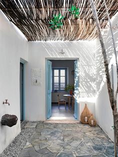 an entry way with stone flooring and white walls