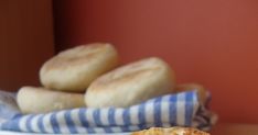 a close up of a sandwich on a plate with other pastries in the background