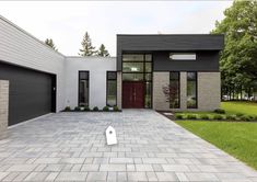 a modern house with two garages in the front and one on the other side