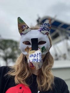 a woman wearing a cat mask with the word little bite on it's face