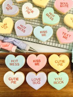 heart shaped cookies that say kiss me, cutie me, love you rock and not mess