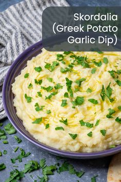 a bowl filled with mashed potatoes and garnished with parsley