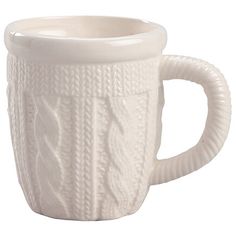 Cozy up with this Sweater Mug, a charming white ceramic mug that brings the warmth of knitwear to your favorite beverage. The exterior is intricately molded with a cabled knit design, adding unique texture and visual appeal. Perfect for sipping hot cocoa by the fire or as a decorative display piece, this mug holds a generous 16 oz. of your favorite drink. Its detailed design makes it an ideal gift for the colder months. Measures 5 1/4" long x 3" wide x 4 1/2" high. Hand wash. Do not place in microwave. Winter Mugs, Burr Basket, Letter Stockings, Winter Mug, Nostalgic Candy, Unique Sweater, Kitchen Clothes, Plants For Hanging Baskets, Seal Gifts