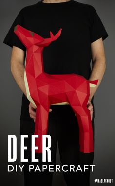 a man holding a red paper deer with the words deer diy papercraft on it