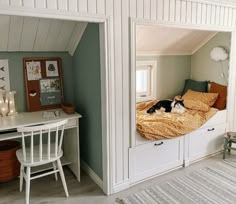 a dog laying on top of a bed in a room next to a desk and chair