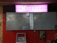 there is a sign that says hosier on the wall above it and a ladder in front of it