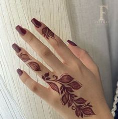 a woman's hand with hennap on it and flowers painted on the palm