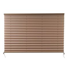 a tan colored blind with holes in the top and bottom, on a white background