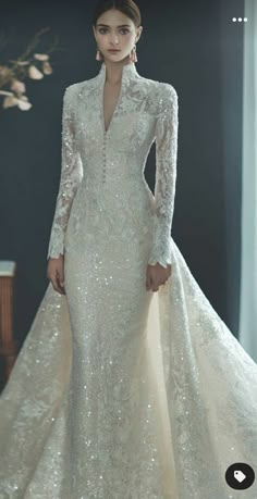 a woman in a wedding dress with long sleeves