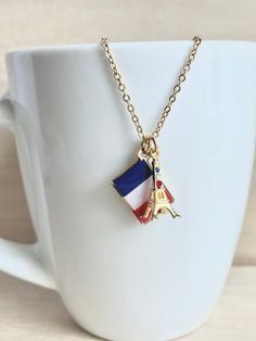 This dainty French flag & Eiffel Tower necklace is made of the following: (1) Gold plated French flag charm, which is made of the printed flag pattern with transparent epoxy (size: 10.5 x 15.5 mm) (2) gold plated Eiffel Tower charm with glass crystal (size: 17 x 17.5mm) (2) Gold plated chain and findings ✏️ Please choose the exact length of the chain (the length includes clasp and findings) ❣️ If you are unsure about which length to choose , please leave me a note to request an extension cha Eiffel Tower Gold Necklace, Eiffel Tower Necklace, Ring Charm Necklace, Souvenir Jewelry, France Flag, French Flag, Travel Souvenirs, Christmas Charms, Diamond Charm