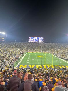 a football stadium filled with people watching the game