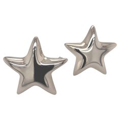 two silver star shaped studs on white background with clipping out to the side