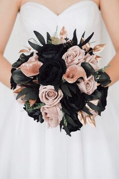 a bridal bouquet with black and pink flowers