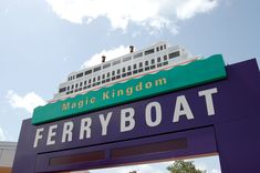 there is a sign that says ferryboat with a cruise ship in the back ground