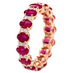 18 Karat Rose Gold 4.00 Carat Oval-Cut Ruby and Diamond Eternity Band Ring This enchanting vivid red ruby and diamond band is magnificent. The solitaire horizontally placed oval shape ruby in grain prong setting is complemented with two round diamonds on either side, making the band more distinctive. The ideally cut, size, and matching shape of the rubies surround the band’s beauty with the diamonds in between each makes it more glorifying. The band shows the delicate detailing consisting of the Luxury Red Eternity Band For Engagement, Luxury Red Half Eternity Ring, Luxury Rose Cut Diamond Eternity Band As Gift, Ruby Ring Designs, Ruby Eternity Band, Pink Sapphire Band, Emerald Eternity Band, Ruby Bands, Ruby Diamond Rings