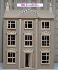 a doll house with the door open and windows closed