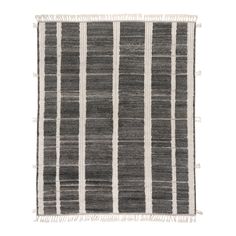 a black and white striped rug with fringes on the bottom, in front of a white background