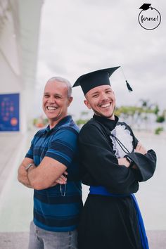 two men in graduation caps and gowns are posing for the camera with their arms around each other