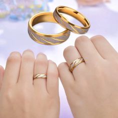 two women's hands with wedding rings on their fingers and one woman's hand holding