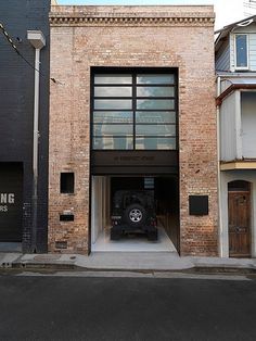 a car is parked in the entrance to a building that has been converted into a parking garage