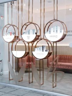 a store front with round mirrors on the glass and metal bars hanging from it's sides