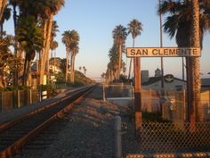 a train track with palm trees and a sign that says san clemente on it