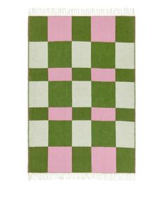 a pink and green checkered rug with fringes