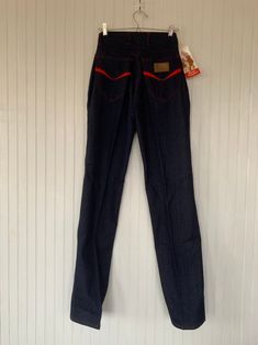 "Rare NWT Vintage Early 80s High Waisted Dark Denim Blue Jeans, by Hush Puppies. New condition and unworn with original tags. Super high rise waist. Front & back pleated down center of leg. Dark denim with red stitching, embroidered back pockets with basset hound logo. Amazing Original condition with original store tags! Brand - Hush Puppies Condition - Original. Deadstock from the 80s, New with original tags 100% Cotton Made in Taiwan Machine Washable Vintage Size - 8 Size - 26\" waist Best Red Full-length Denim Jeans, Retro Stretch Flare Jeans, High Waist Red Denim Jeans, Red Retro Denim Bottoms, Retro Fitted Full-length Jeans, Retro Full-length Fitted Jeans, Retro Fitted Full Length Jeans, Fitted Retro Medium Wash Pants, Retro Fitted Straight Leg Jeans