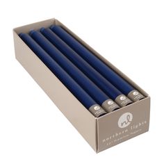 six blue candles in a box on a white background