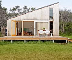 a small wooden house sitting on top of a lush green field