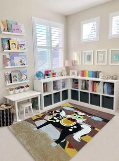 a child's room with bookshelves, toys and pictures on the wall