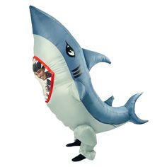 an inflatable shark with a man on it's back and his mouth open