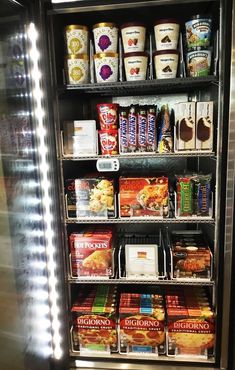 an ice cream display in a store filled with lots of different types of food and drinks