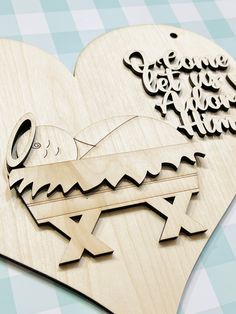 a wooden cutout of a baby jesus in a manger with the words love you to the moon and back