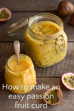 a jar filled with yellow liquid next to two halves of fruit on a wooden table