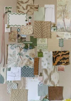 a wall covered with lots of different types of fabric and papers on top of each other