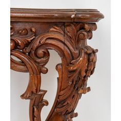 an ornate wooden table with carved carvings on the top and bottom, against a white background