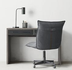 an office chair sitting in front of a desk with a lamp on top of it