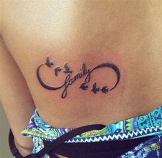 a woman's lower back tattoo with the word love written in cursive writing