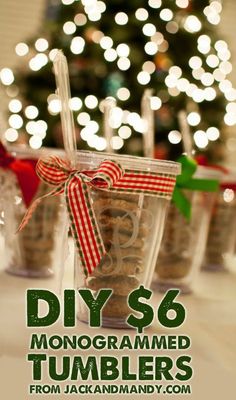 three clear cups filled with nuts on top of a table next to christmas trees and lights