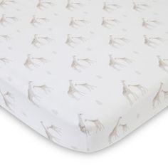 an image of a baby crib sheet with giraffes on it