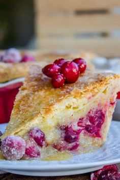 a piece of pie on a plate with cranberries