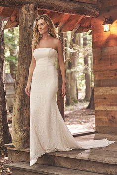 a woman in a white dress standing on steps