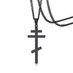 a black cross is attached to a chain