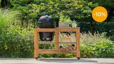 an outdoor bbq grill on a wooden stand with 10 % off sign above it