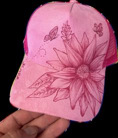 This one-of-a-kind hand-burned pink trucker cap combines stunning floral artistry with a touch of whimsy! Featuring a beautifully detailed flower and butterfly design, each line is carefully burned into the cap's surface, creating a distinctive, personalized look. Whether you're a lover of nature, a boho fashion enthusiast, or looking for a unique gift, this custom art hat is perfect for making a bold yet artistic statement. Made from high-quality materials, this pink ball cap features an adjustable back for a comfortable fit and breathable mesh for everyday wear. The intricate floral design, paired with the playful butterflies, adds a refreshing vibe to any casual outfit. It's not just a cap--it's a wearable piece of art that stands out wherever you go! Key Features: - Hand-Burned Art: In Pink 5-panel Trucker Hat For Spring, Pink Trucker Hat With Curved Brim For Festivals, Artistic Adjustable Trucker Hat, Adjustable Pink Trucker Hat, Bohemian Pink Flower Hat, Pink Bohemian Flower Hat, Adjustable Flower Hat As A Gift, Adjustable Pink 5-panel Hat, Pink Adjustable 5-panel Hat